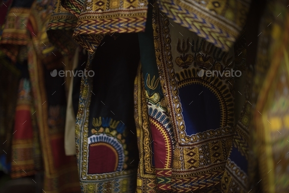 close up shot of african print clothing hanging on rack