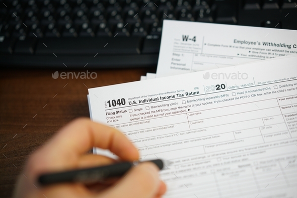 Filling up U.S. tax return form - Stock Photo - Images