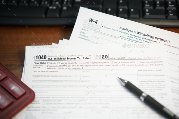 Filling US tax papers  - Stock Photo - Images