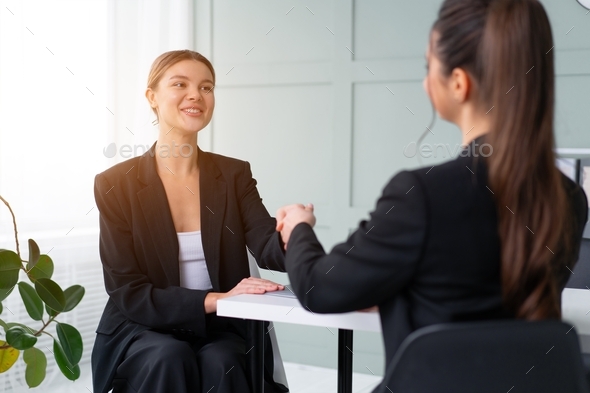 Job interview , Business, career and placement concept. Young blonde woman smiling handshaking