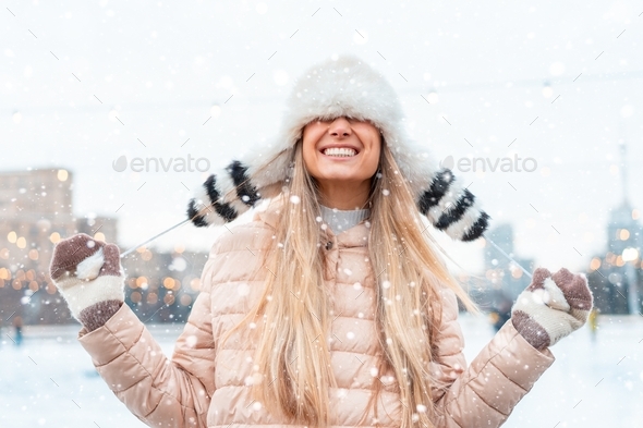 Woman in fluffy fur hat winter jacket standing outdoor joke in snowfall Christmas mood