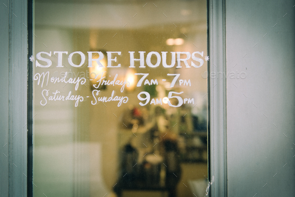 Classic store hours sign on front door