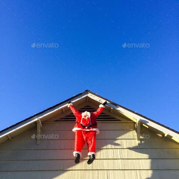 Outdoor Christmas Decoration - Santa Claus hanging from roof ledge ...