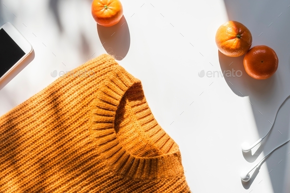 Bright orange and white items lay on white background. Stock Photo by