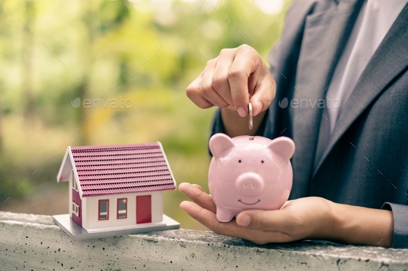 Businesswomen hold piggy banks and put coins in piggy banks to save money with coins to step - Stock Photo - Images