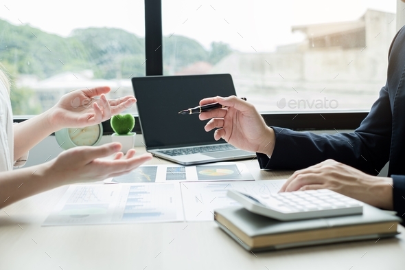 Two business leaders talk about charts, financial graphs showing results are analyzing - Stock Photo - Images