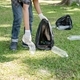 Man&#39;s hands pick up plastic bottles, put garbage in black garbage bags to clean up at parks, avoid - PhotoDune Item for Sale
