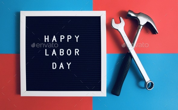 Happy Labor Day sign board together with tools on the red and blue background. 72