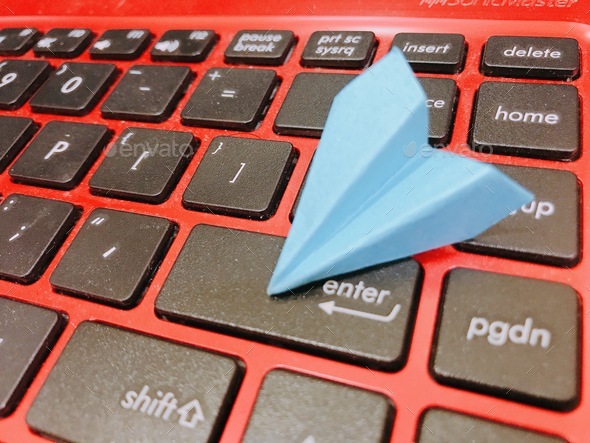Paper plane origami on keyboard - Stock Photo - Images
