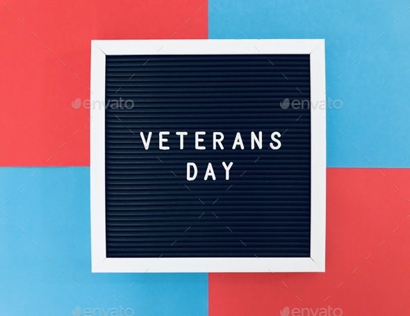 Veterans Day sign board on blue and red background to salute our dearest veterans  - Stock Photo - Images