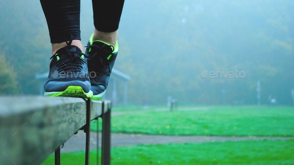 Girl balancing in her sneakers on a ledge outside outdoor recreation stability balance stable - Stock Photo - Images