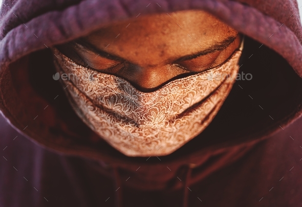 African American man with homemade mask looking down with hoodie - Stock Photo - Images