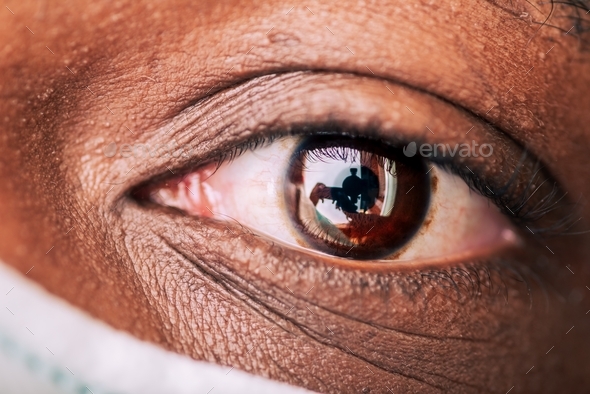 Close up of African American man’s eye wearing mask - Stock Photo - Images