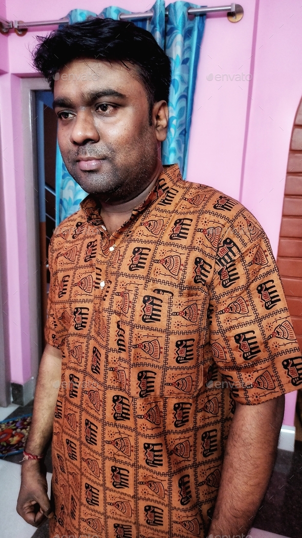 An Indian youth is wearing a traditional dress kurta.