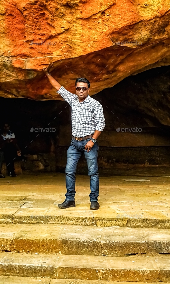 An Indian youth taking pictures in a cave in the Udayagiri region