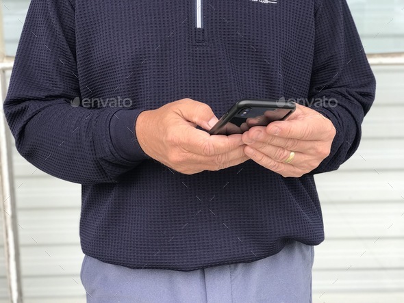 A man is using his mobile phone