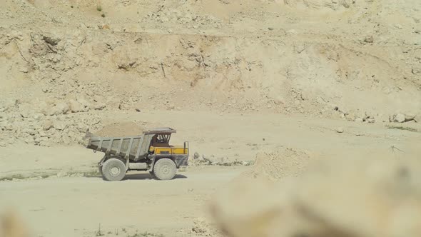 Dump truck with ballast on a construction site alt