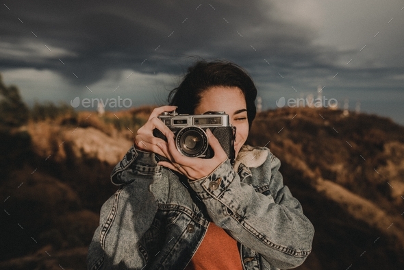 An happy girl with a film vintage camera  - Stock Photo - Images