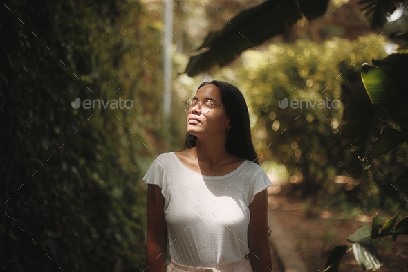Asian girl taking a breath in the forest  - Stock Photo - Images