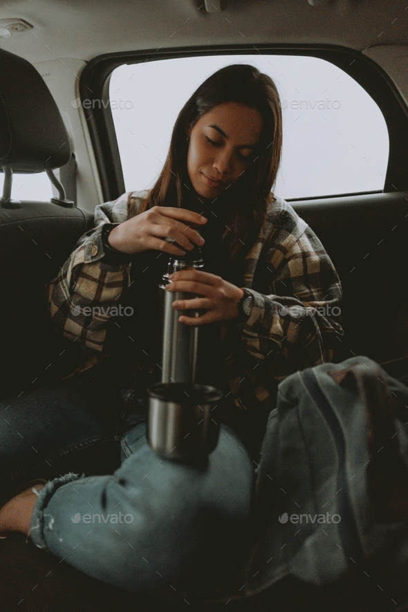 Girl having Coffee Time within a Car - Stock Photo - Images