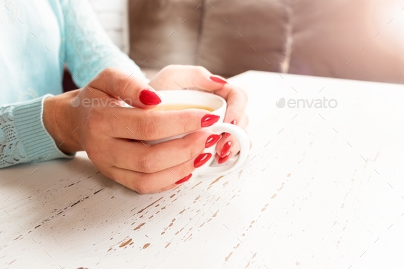 warm up with a cup of tea.Lifestyle, female hands