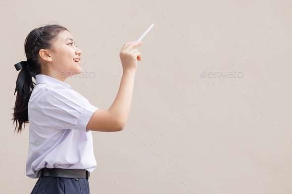 Young Asian student in school uniform girl teen hand drawing bring imagination new idea concept.