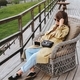 Stylish girl with a phone in her hands is resting on a terrace in the mountains of Georgia. - PhotoDune Item for Sale
