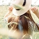 Portrait of a girl in a straw hat in a wild field of oats and rye and wheat. Vertical photo - PhotoDune Item for Sale