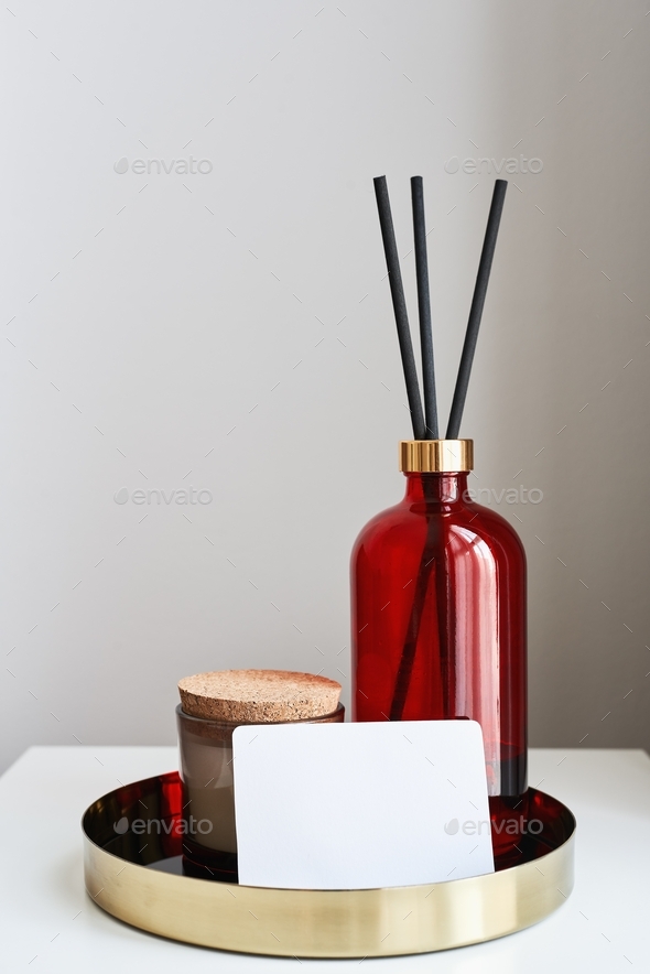 Metal tray with aroma candle, room fragrance diffuser of red color and