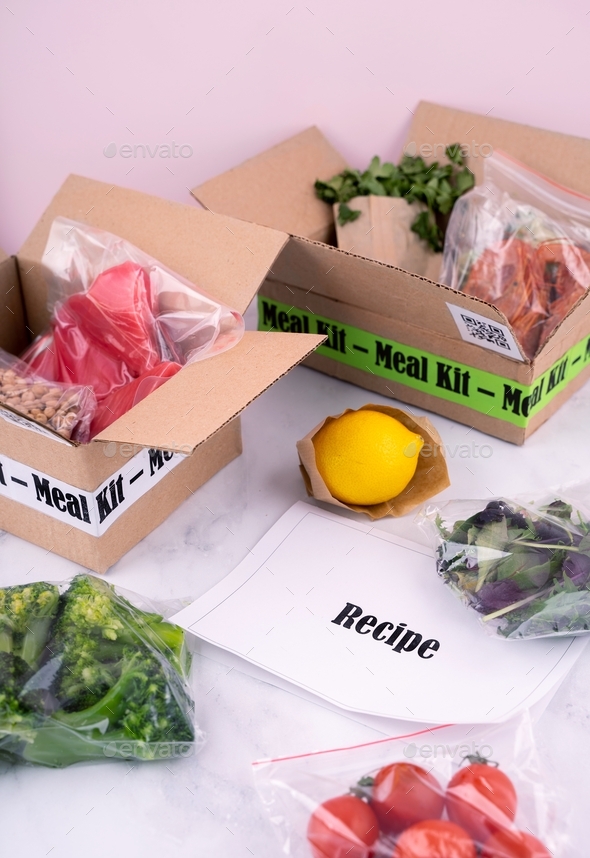 Online Home Food Delivery. Craft Box with packed tuna, shrimp, vegetables and recipe card on a kitch