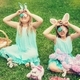 Cute little children wearing bunny ears on Easter day sitting on grass in garden - PhotoDune Item for Sale