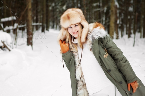 Woman smile during walk in winter forest