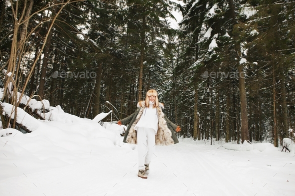 Positive girl walk in winter snow forest