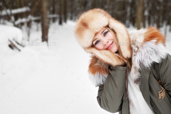 Woman smile during walk in winter forest