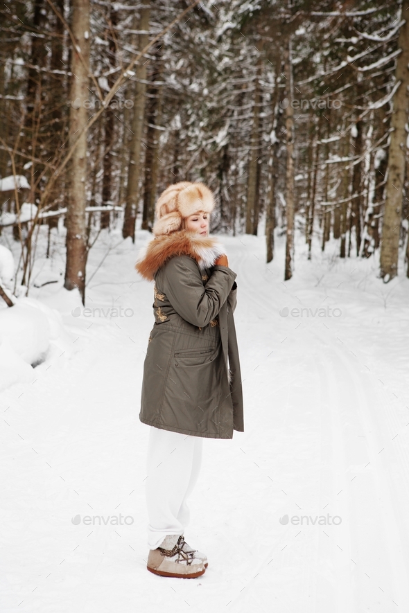 Woman meditation enjoy calmness of winter snowy forest