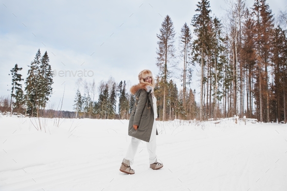 Happy woman walk in snow weather outdoors, hike