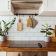 Hanging kitchen with white tiles wall and wood tabletop.Green plant on kitchen background - PhotoDune Item for Sale