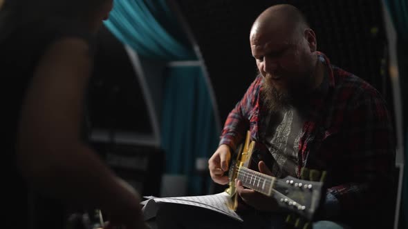 Young Beautiful Girl in Lesson with Experienced Guitarist in Studio alt