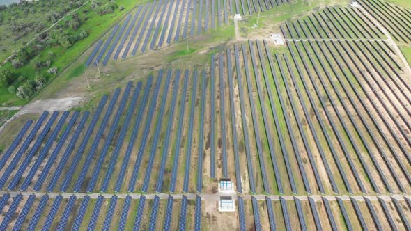 Aerial Top View on Solar Power Station in Green Field on Sunny Day. Solar Farm alt