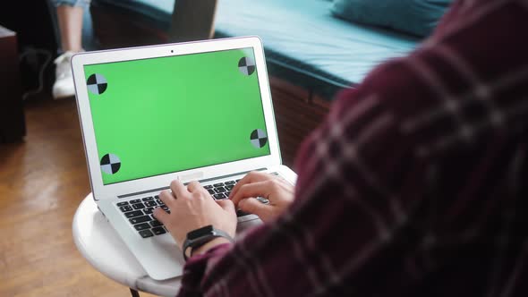 Closeup of Hipster Freelancer Male Hands Using Green Screen Chroma Key Laptop Typing Working in alt