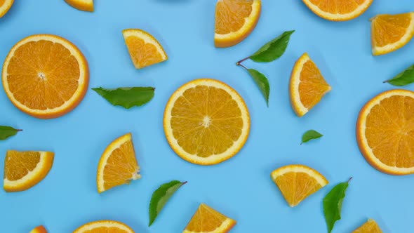 Rotating Background with Slides of Orange and Leaves on a Blue Background Trendy Summer Fruity