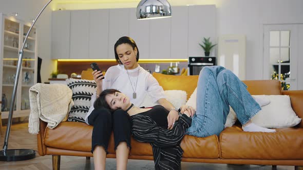 Happy Mixer Race Lesbian Couple Resting at Home for Weekend alt