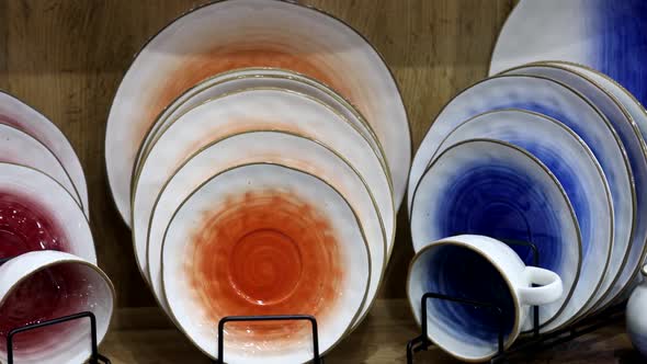 Differentcolored Porcelain Cups Plates and Saucers