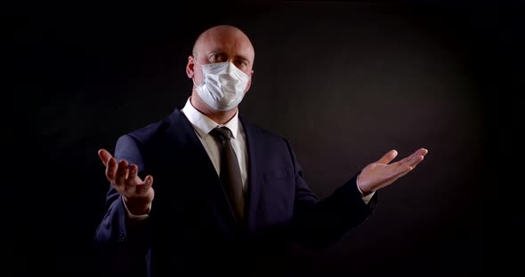 Portrait of a Man in a Business Suit on a Black Background alt