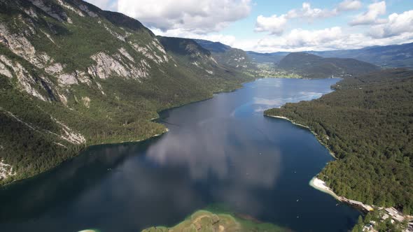 Aerial view on Bohinj lake between mountains with forest in Slovenia, Europe alt
