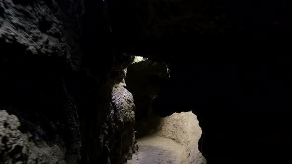 Speleology, cave, dungeon, dark tunnel, underground excavations. The old cave is formed by water alt