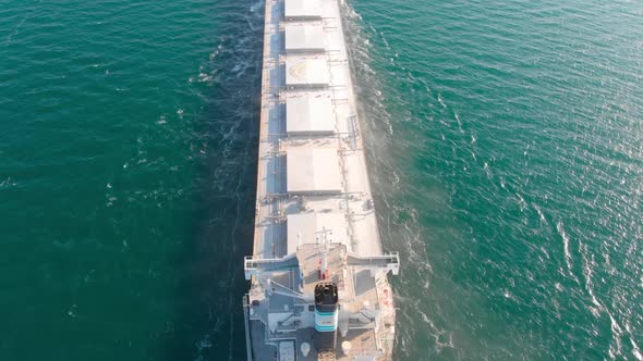 The Bulk Carrier Left the Port and Moves in the Right Direction at High Speed. alt