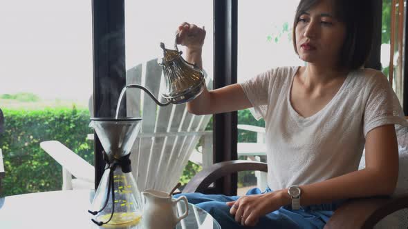 Woman drip coffee in the cafe