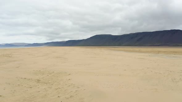 Flying Over Empty Sand Dunes Of Beach In Iceland. - aerial alt
