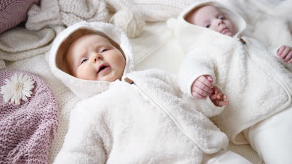Cute Baby Girls Lying Together And Holding Hands alt